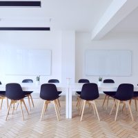 一位短发女性内容审核专家在会议室审阅文件资料，表情认真专注